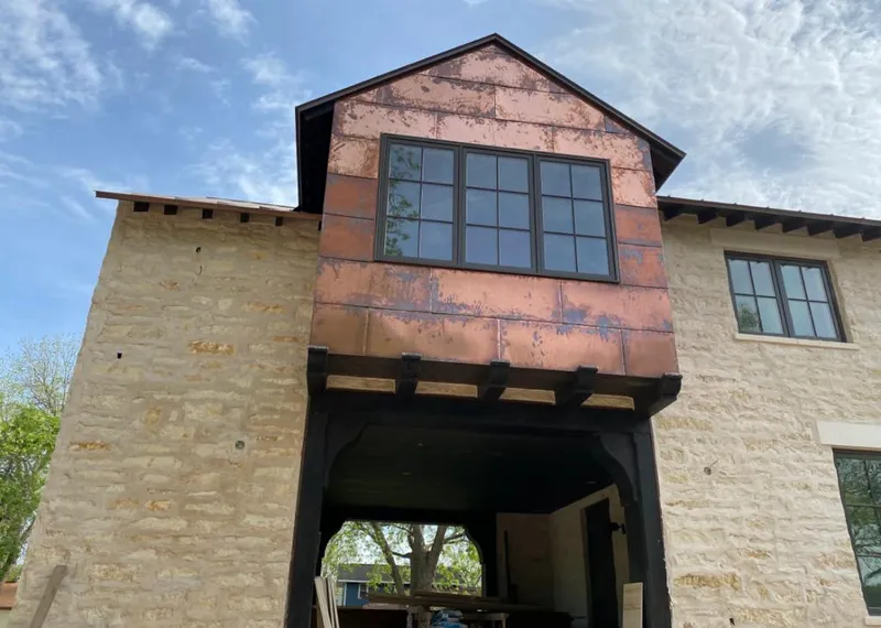 Copper metal panel facade on a stone building for Metal Roof Coating in Fishhook