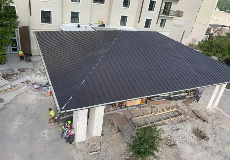 Metal roofing installation team working on a commercial building in Fishhook