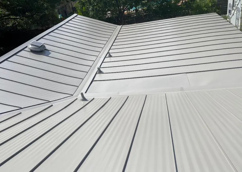 Solar attic fan installed on a metal roof for Roof Ventilation in Fishhook